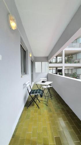 a room with a table and chairs on a balcony at Gaiapart in Vila Nova de Gaia