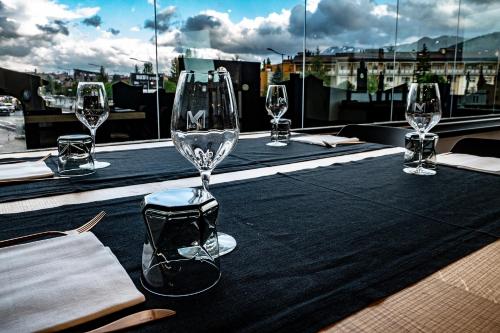 a table with wine glasses on top of a roof at My Suite Hotel in LʼAquila