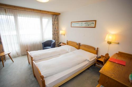 Ein Bett oder Betten in einem Zimmer der Unterkunft Motel de la Gruyère Restoroute