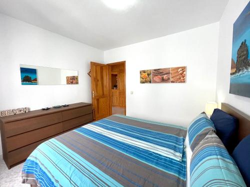 a bedroom with a bed and a dresser at La Playa in Órzola