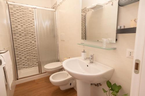 a bathroom with a sink and a toilet and a shower at B&B Cantico Delle Creature in Assisi