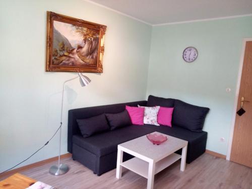 a living room with a couch and a table at Ferienwohnungen Schenk Schmitz in Bad Bertrich