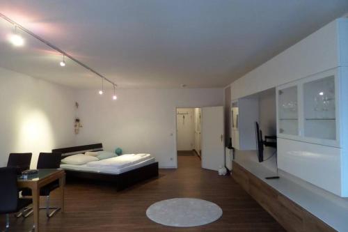 a living room with a bed and a couch in it at Apartment Am Kurpark in Bad Frankenhausen