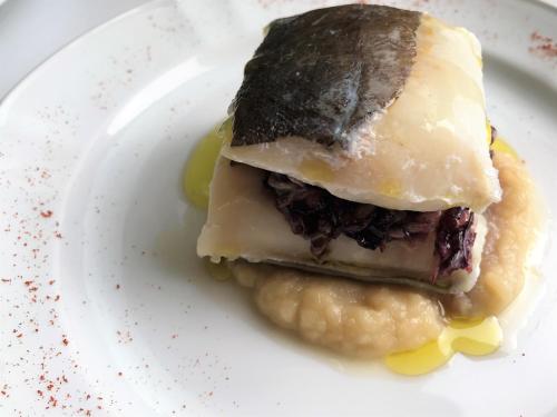 a white plate with a piece of food on it at Perugia Plaza Hotel in Perugia