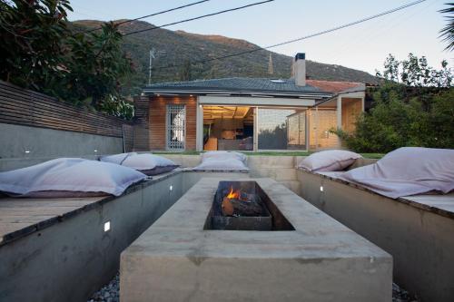 a backyard with a fire pit and a house at Spa Villa Skaloma in Nafpaktos