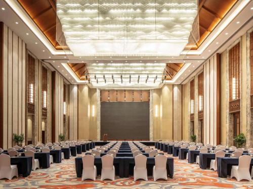 a large room with chairs and a screen in it at Pullman Changbaishan Resort in Fusong
