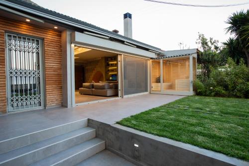 a house with a patio and a couch in a yard at Spa Villa Skaloma in Nafpaktos