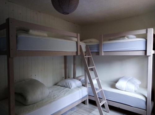 two bunk beds in a room with a ladder at REPERE D'ALL in Sainte-Croix-sur-Orne