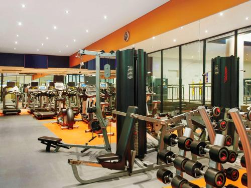 a gym with several treadmills and machines at Mercure Melbourne Albert Park in Melbourne