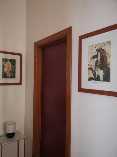 a door in a room with a picture of a horse at Annina Home in Paestum
