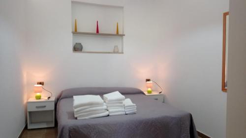a bedroom with a bed with three pillows on it at casa dei limoni in Peschici