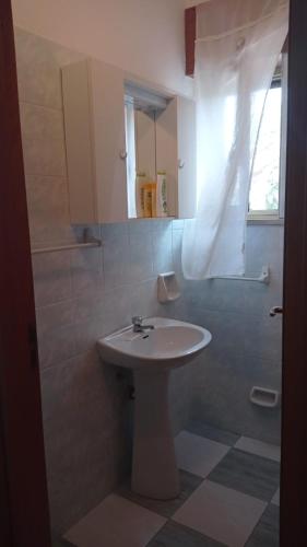 a bathroom with a white sink and a shower at casa dei limoni in Peschici