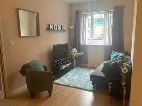 a living room with a couch and a mirror at Absolute Stays in Sherwood- Nottingham Castle- Capital FM Arena Nottingham- Contractors-Free WIFI- Free Parking- Long and Short Stays- Families-East Midlands Airport-Trent Bridge-Actors-Aria Court- Mansfield in Nottingham
