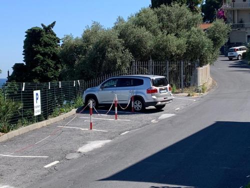 a car is parked on the side of the road at Baia dei Gabbiani in San Lorenzo al Mare