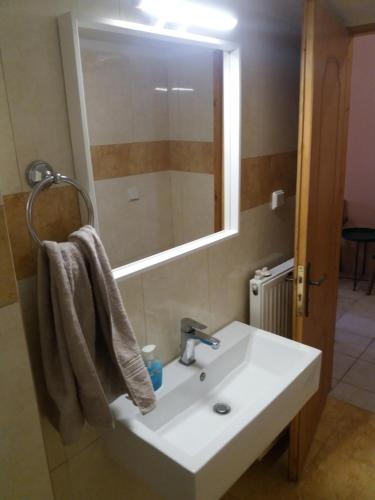 a bathroom with a white sink and a mirror at Nestor Sea Studio in Preveza