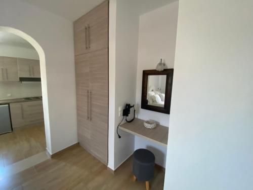 a room with a table and a mirror on a wall at Chill Out Studio in Mýkonos City