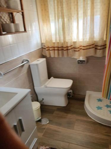 a small bathroom with a toilet and a sink at Casa de Marga in San Pedro