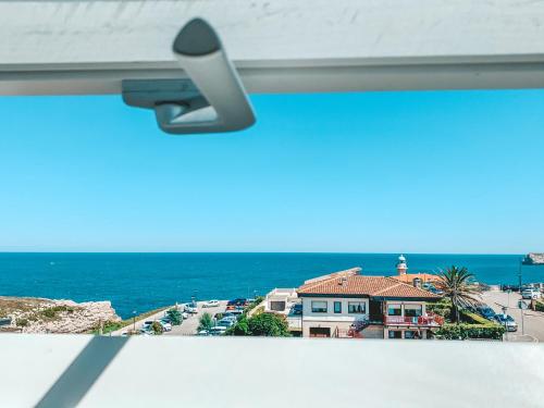 a view from a window with a view of the ocean at Hotel Playa de Los Locos in Suances