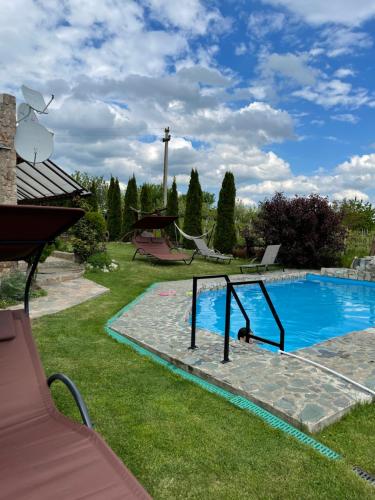 a pool with a swing set in a yard at Wineyards Salin in Turda