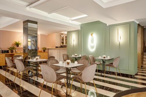 a restaurant with tables and chairs in a room at Hotel Luxembourg in Thessaloniki