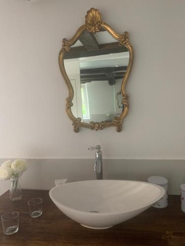 a bathroom with a white sink and a mirror at Maison de Charme "Le Moulin d'Hagenthal" - Chambre Baroque in Hagenthal-le-Bas