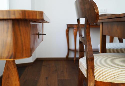a wooden chair in a room with two wooden tables at Premium Residences Rauris incl Sommercard in Rauris