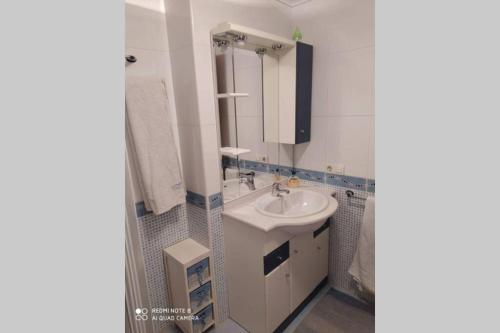 a white bathroom with a sink and a mirror at Vivienda Briviesca La Vega 2 in Briviesca