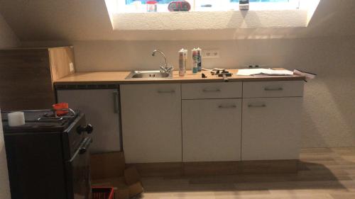 a kitchen with a sink and a counter top at Idyllische kleine Ferienwohnung in Obdach