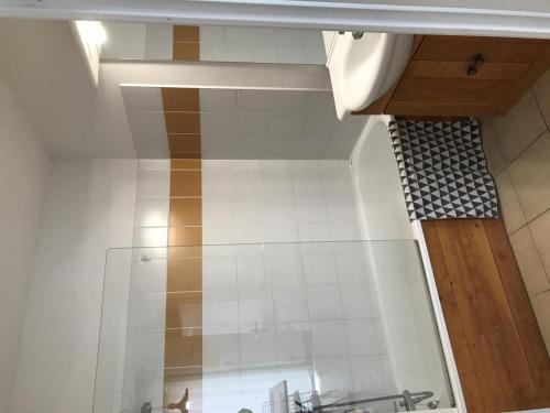 La salle de bains est pourvue d'un lavabo et d'un mur en carrelage. dans l'établissement appartement studio, à Prayssac