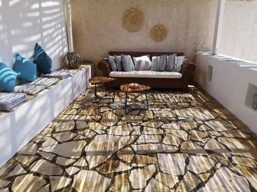 a living room with a couch and a rug at Elena Studio in Logothetiánika