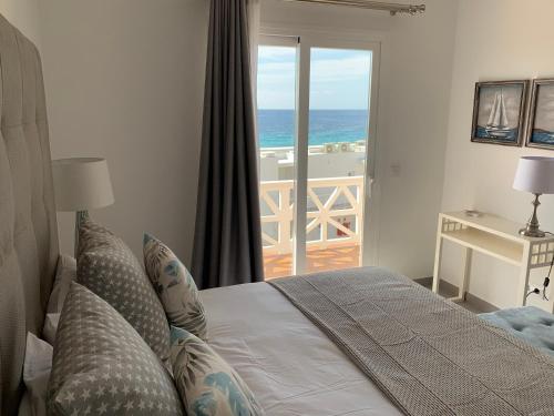 מיטה או מיטות בחדר ב-Apartamento en Playa Santo Tomas
