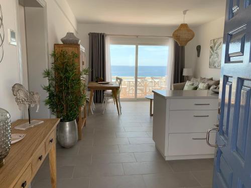 a kitchen with a view of the ocean at Apartamento en Playa Santo Tomas in Es Migjorn Gran