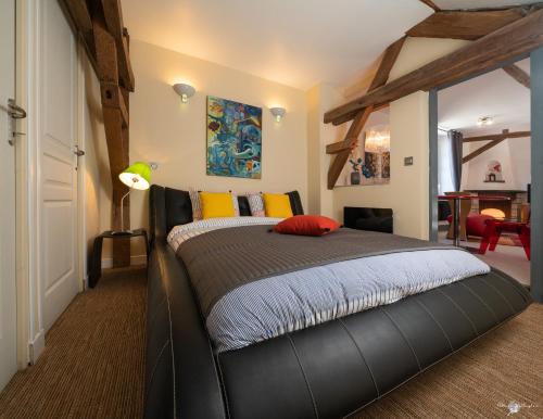 a bedroom with a bed with a black bed frame at la Forge du Roy in Blois