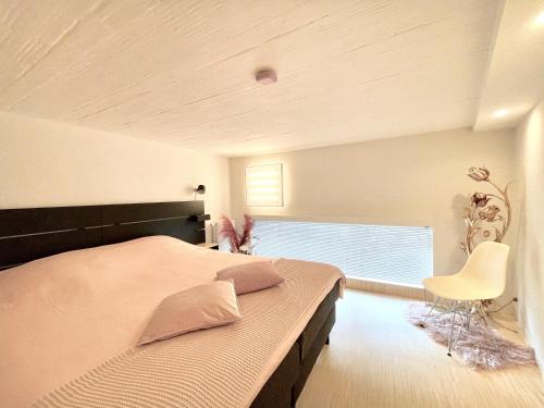 a bedroom with a large bed and a window at Desk Till Dawn in Ghent