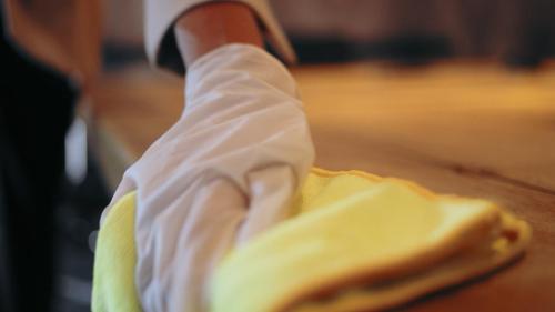 a hand in a white glove holding a piece of food at Holiday Inn Express Chennai OMR Thoraipakkam by IHG in Chennai