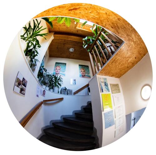 a spiral staircase in a building with plants at Beauty-Spa Apartment in Děčín