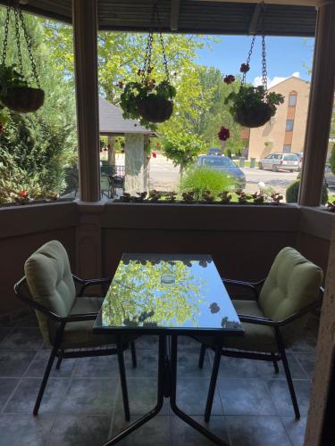 a table and chairs in front of a window at Villa i SPA Stević in Veliko Gradište