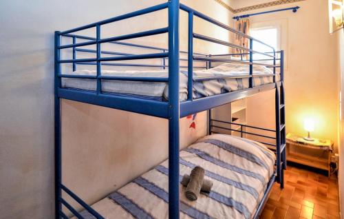 two bunk beds in a room with a teddy bear at Nimes-Camargues in Garons