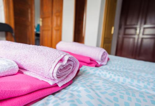 a pile of towels sitting on top of a bed at Cozy river view apartment in Karlovac