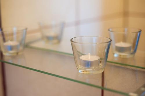 four empty glasses sitting on a glass table at Cozy river view apartment in Karlovac
