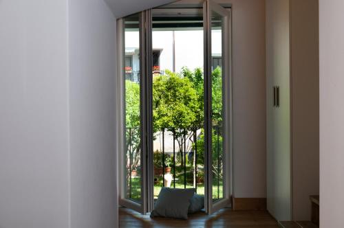 an open glass door with a pillow on the floor at Casa Teresinella Garden in Torre Annunziata
