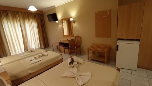 a hotel room with two beds and a kitchen at THEMIS BEACH in Paralia Katerinis