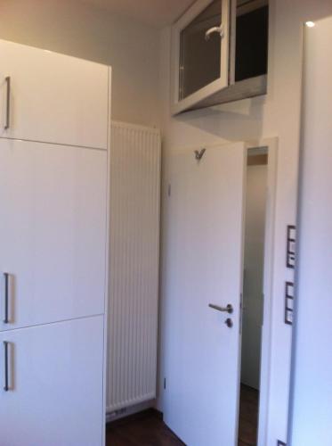 a room with a white door and a white cabinet at Joanna Apartment - MA Rheinau 3 in Mannheim