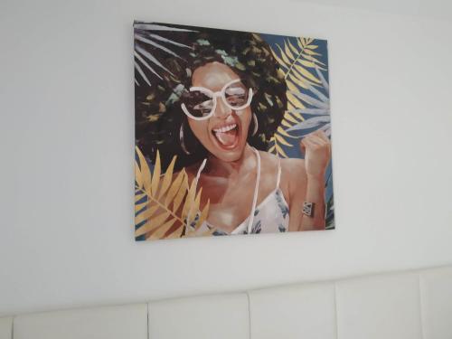a picture of a woman with sunglasses on a wall at Casas de Tauro in La Playa de Tauro