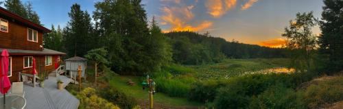 a house with a view of a field next to a house at Otter's Pond Bed and Breakfast in Eastsound