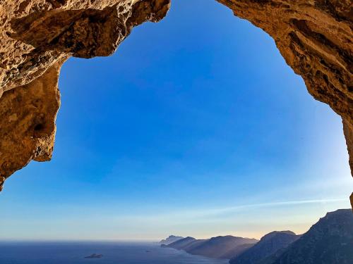 a view of the ocean through a rock cave at Tenuta Novecento Bioagriturismo in Agerola