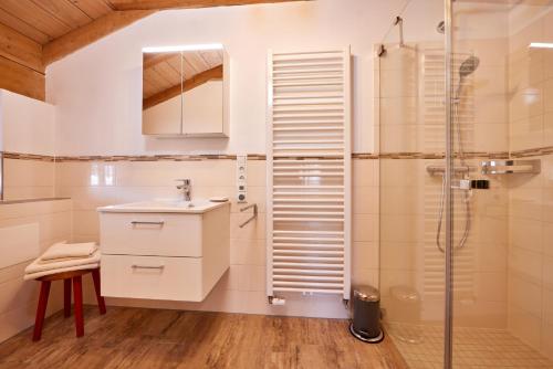 a bathroom with a shower and a sink at Appartements Gasthof Schleifmühle Unterammergau in Unterammergau
