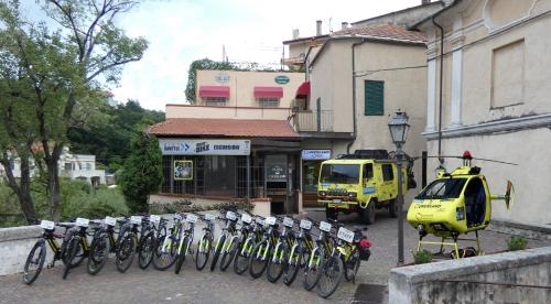 a row of bikes parked in front of a building at Bike Resort Overland in Toirano