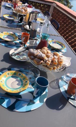 a long table with plates of food on it at VILLA FUENTI BAY -Amalfi Coast- in Cetara