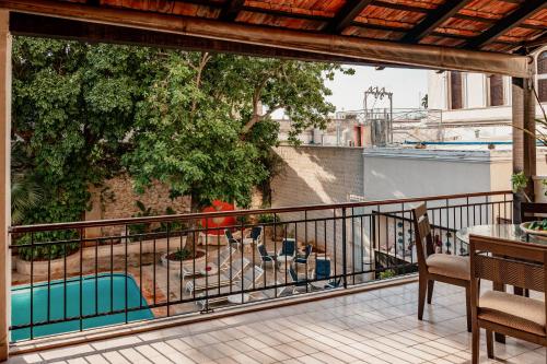 a balcony with a view of a swimming pool at Casa del Balam Merida in Mérida